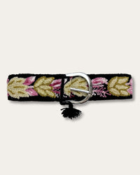 Yagua belt by Ayni Ppacha, fastened: black sheep wool, hand-embroidered with leaves in gold, olive and pink, silver-tone D-buckle with tassel