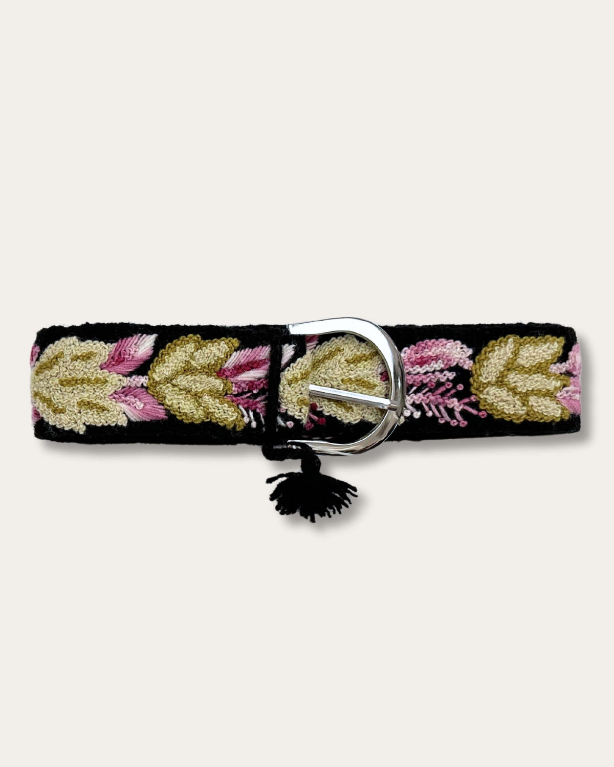 Yagua belt by Ayni Ppacha, fastened: black sheep wool, hand-embroidered with leaves in gold, olive and pink, silver-tone D-buckle with tassel
