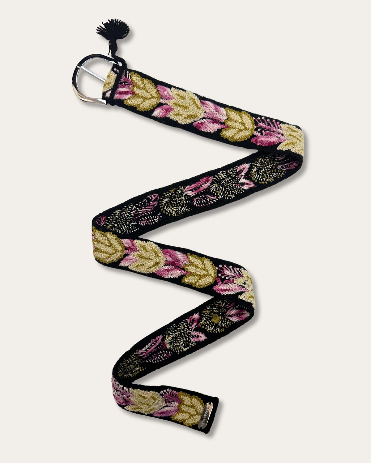 Yagua belt laid out at full length, partly showing the reverse of the hand embroidery