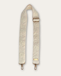 Coco bag strap by Ayni Ppacha at full length: natural white sheep wool, hand-embroidered tone on tone with raised floral and tendril motifs, brass-tone carabiners and slider